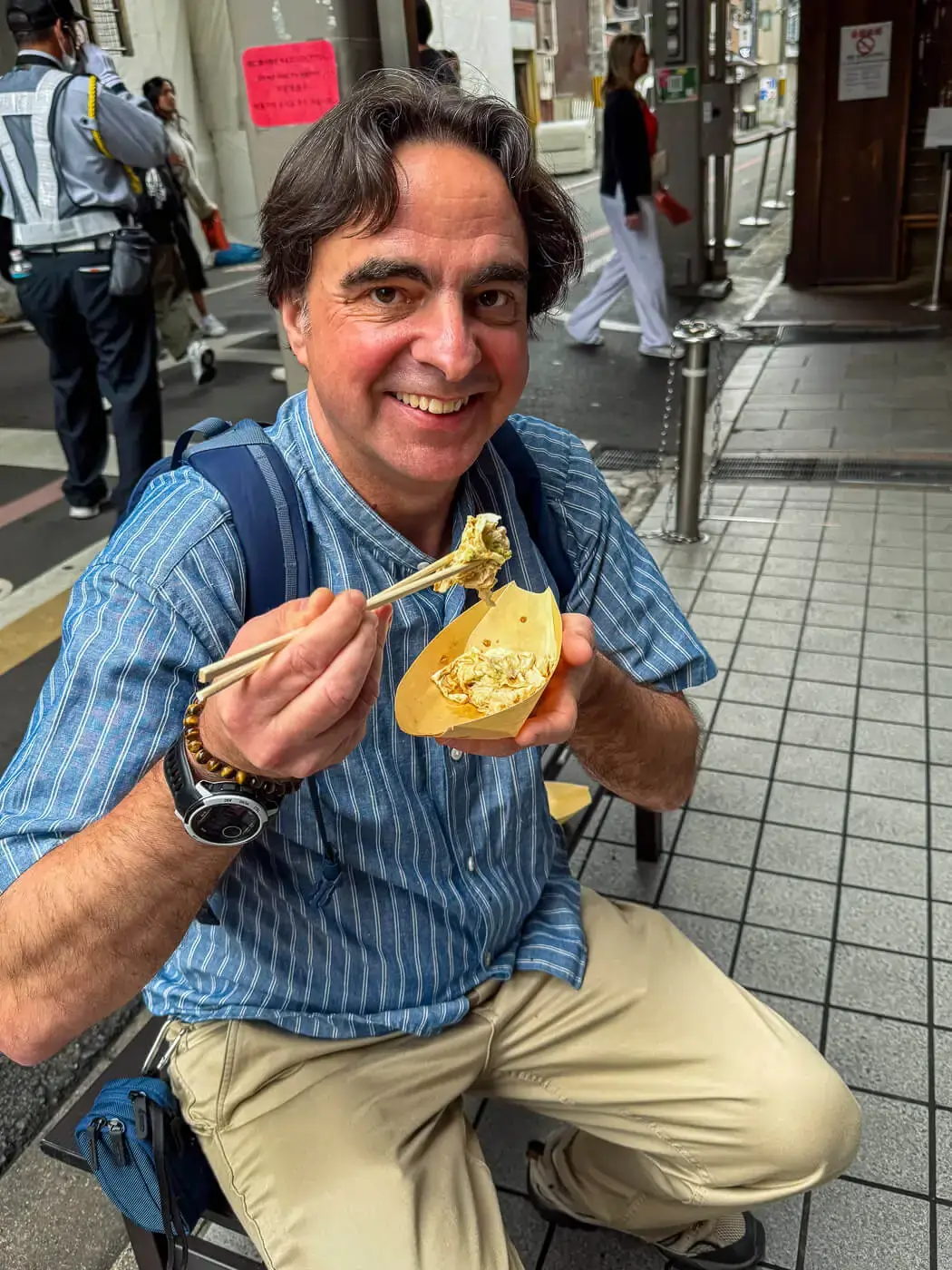 Chris P King from Food Tours Japan eating yuba at Nishiki Market