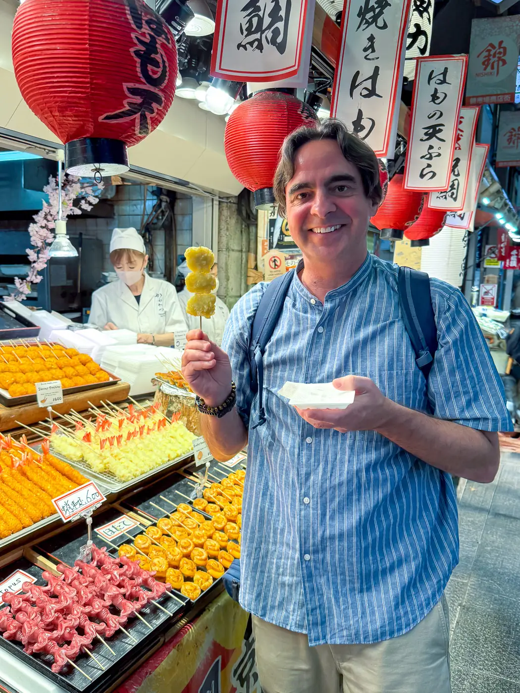 Chris P King eating hamo tempura at Nishiki Market