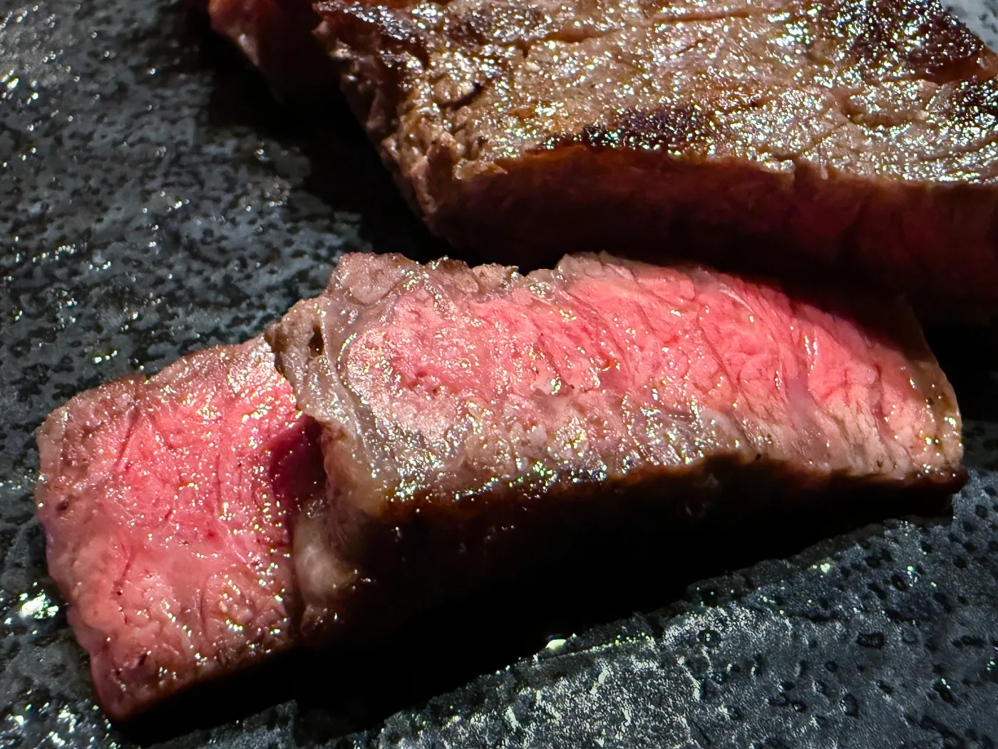 Thick A5 wagyu cut cooked pink on the teppan